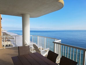 Dining table and two Adirondack chairs on the balcony