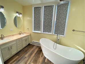 Huge bathroom with tub and shower for first king room