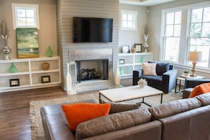 Cozy fireplace, large windows over looking the backyard.