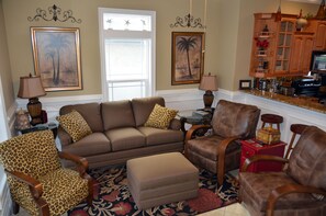 Living room with sleeper sofa and large TV. (1st Flr)