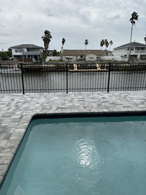 Pool and pool deck with canal