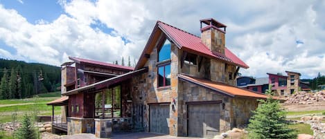 Home exterior with the Kokomo lift in the background.  Large heated driveway.