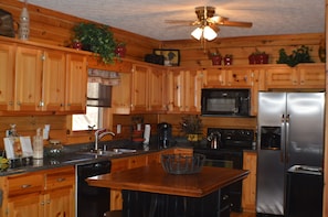 Spacious kitchen with island/breakfast table for four.