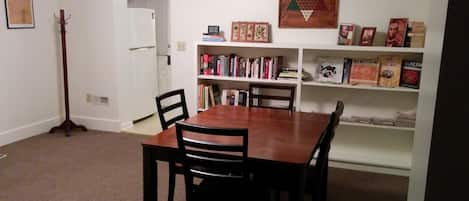 Dining room with books, games and second table for eating (6 person in kitchen)