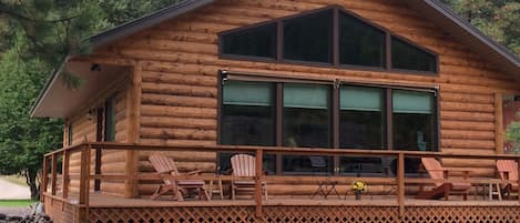 Back deck which faces river.  Large windows allow river view from den & kitchen