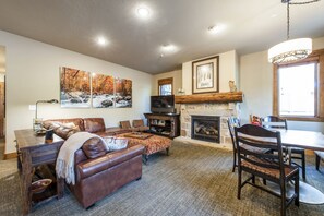 Great room with tv, soundbar, blu-ray player.