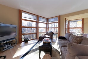 Family room seating area adjacent to kitchen. Direct TV package. 