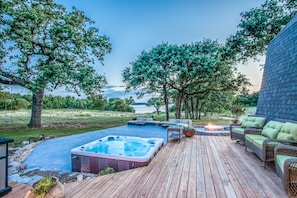 Large outdoor deck and patio complete with gas grill and hot tub.