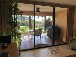 View from living room of lanai & grassy lawn. (No grill anymore per Maui code.)