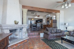 A fireplace divides the living room for the dining area