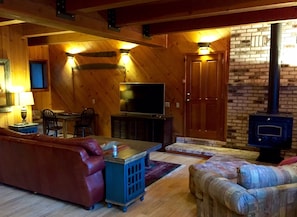 Living room with 54" LCD, DVD Player, wood stove, gaming table