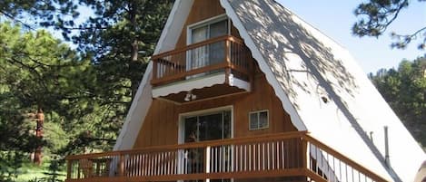 Outside front view of the A-Frame. Charm and comfort nestled in the woods!