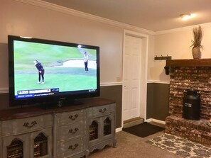 Living Area with 55" Television, Front Door, Fireplace.