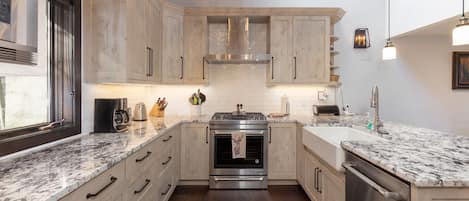 beautifully renovated kitchen with all stainless steel appliances and gas range