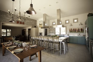 Two 4-burner Gaggenau cooktops, 2 dishwashers, two sinks, and plentiful seating