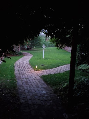 Walk through a pergola filled with wisteria, to an infinity-edged backyard.