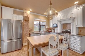 The kitchen is fully stocked with dishes, cookware and bakeware.
