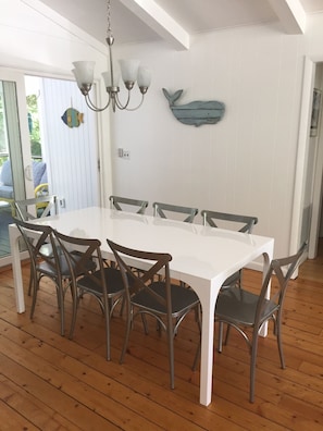 Dining table with 8 chairs.  Bar counter with 4 stools.