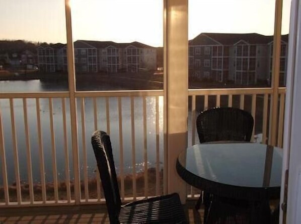Enjoy a drink on the screened in porch after a day at the beach, top floor