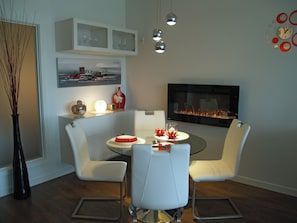 Cozy dining-room features a romantic fireplace and dimmable lights.