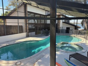 View of pool, spa and home.