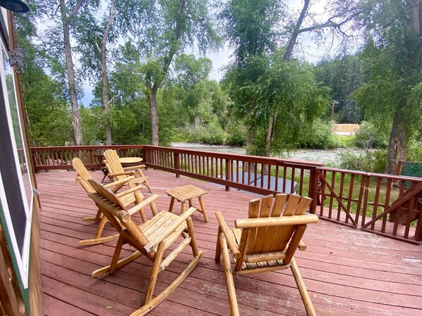 Deck with Adirondack Chairs Overlooking River