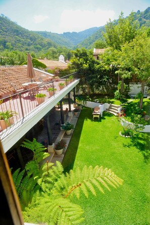 Garden view from the 2nd story apartment.  W/ surrounding green hills in backgnd