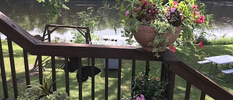 Walkout deck from sun porch, river within 30 feet of cottage