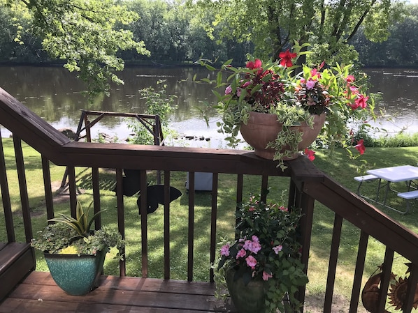 Walkout deck from sun porch, river within 30 feet of cottage