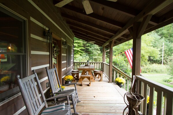 Front porch with rocking chairs and picnic table.