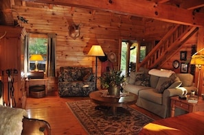 The cabin is beautifully decorated and has lots of comfy chairs and sofas.