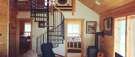 Living Room looking at bedrooms & loft. Reclining couch, backup fireplace 