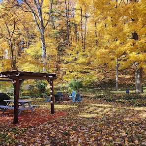 Backyard: firepit/chairs, Pergola, Grill, table/chairs for 2 in the woods.