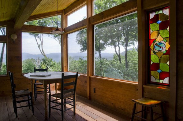 The 3 season screen porch with dinning table, rocking chair and pullout bed.