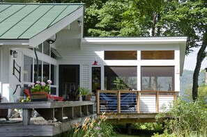 A deck with a view, gas grill and firepit overlooking gardens and the Green Mtns