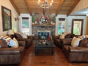 Front living room area with oversized comfy chairs by the wood burning fireplace