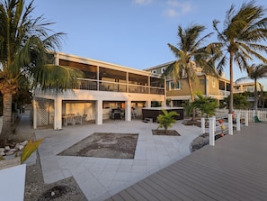 Spacious back yard with pavers, hot tub, grille and hammock.