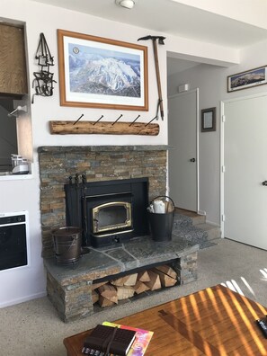 We replaced the old brick with a new hearth and mantle with convenient storage