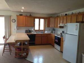 spacious fully equipped kitchen.  Open plan to family room with view of the lake