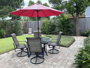 Beautiful paved back yard, with outdoor dining.