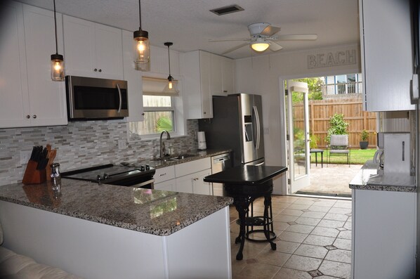 Large modern kitchen with french doors leading to the private back yard. 