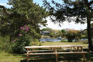 Backyard picnic area overlooking lower lot to Herring river beach and dock.