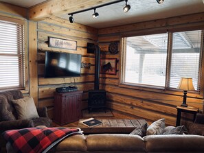 Living area with window looking out at Middle Fork of the Little Laramie River.