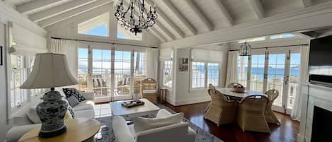 The sunny main living area offers sweeping oceanfront views