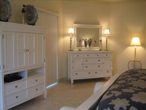 Master bedroom. Doors on either side of armoire lead on to patio.