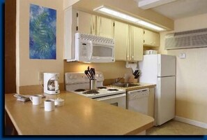 Full kitchen complete with appliances, utensils and dishes