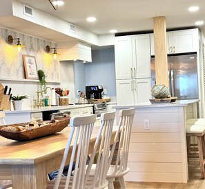 Brand new custom kitchen featuring quartz countertops and soft close cabinets.