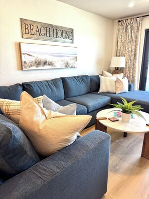Cozy performance fabric sectional with chaise overlooking the sea.