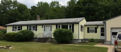 Street side view of the house in summer.