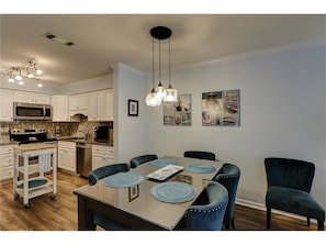 fully stocked kitchen with dining room seating for 6 people